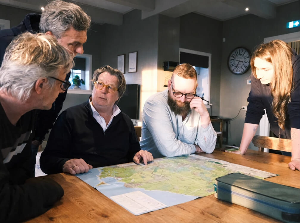 the Mapcreator team discussing a map at a team event