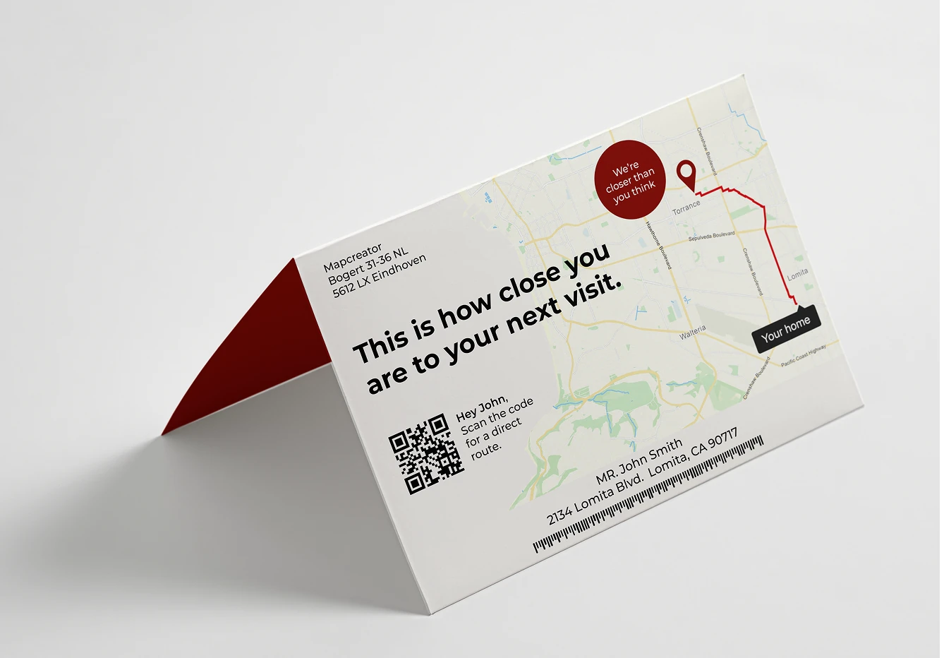 A folded printed card featuring a small map, a highlighted route from a home location, a QR code, and text indicating proximity to a business or destination.
