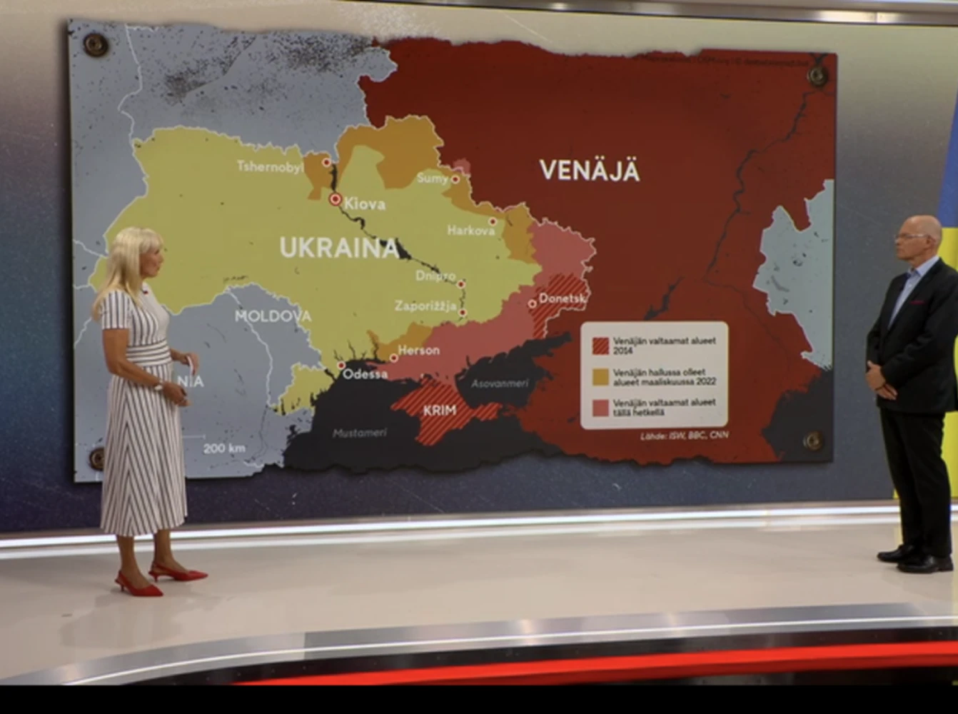 MTV OY news presentors with a map