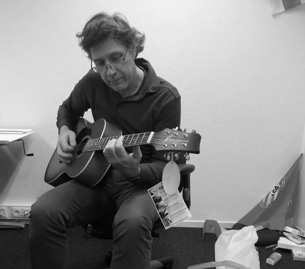 black and white portrait of Rob Bieling playing guitar